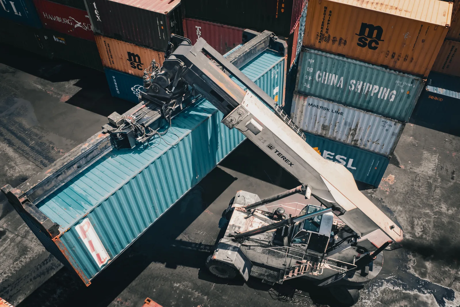 Reach stacker loading a container at a port terminal